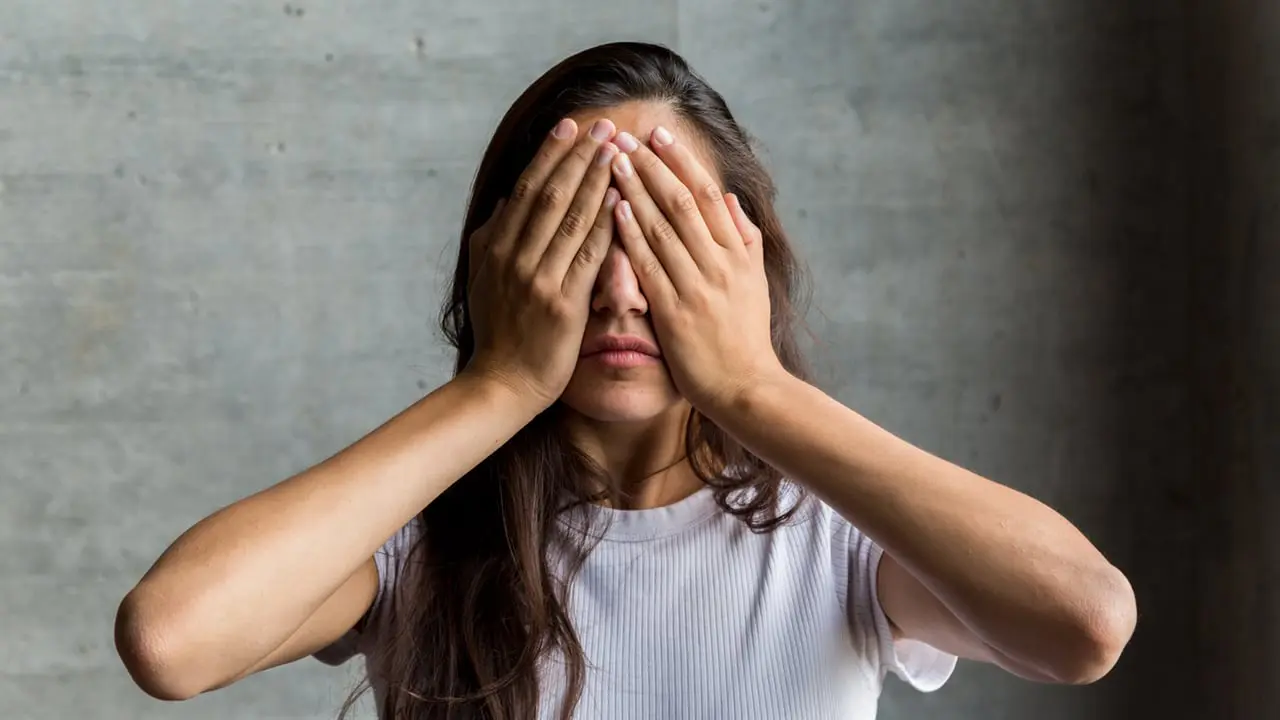 A woman covering her eyes - Avoidance – Coping Strategies?