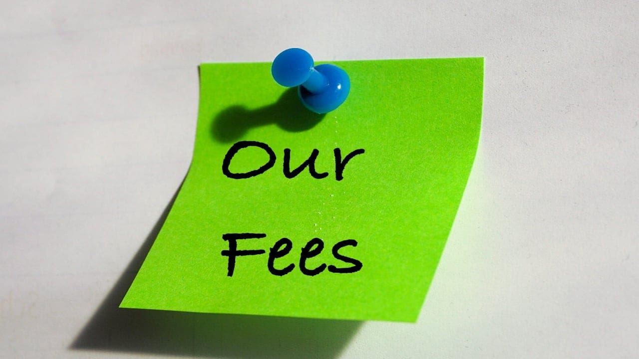 Our fees written on note, pinned to a board