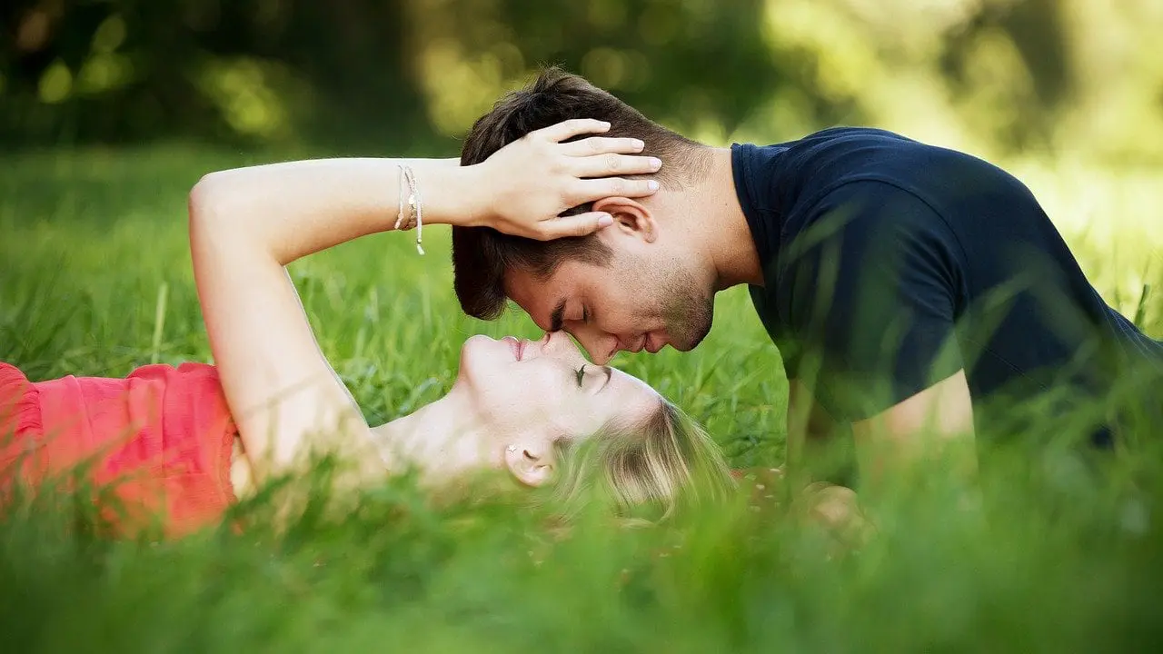 A couple kissing in a field - Reclaiming the Intimacy in Your Relationship